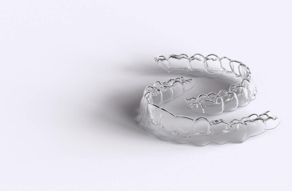 Removable teeth aligners for teeth straightening on a white background. Orthodontic treatment for a beautiful smile.