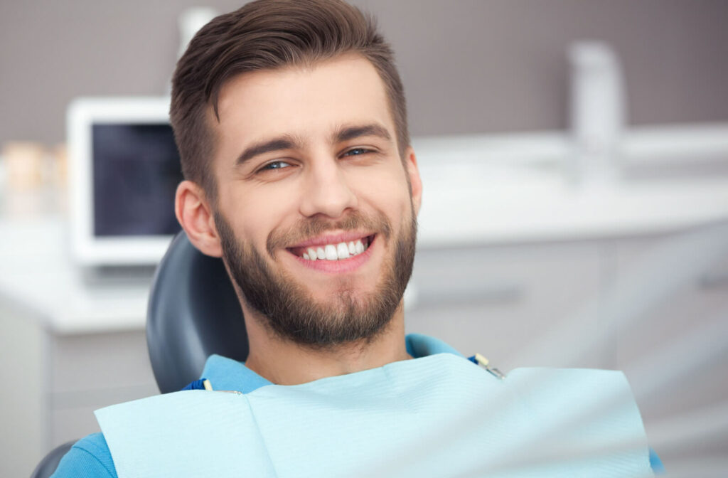 Close-up of a man with dental bib smiling in a dental office