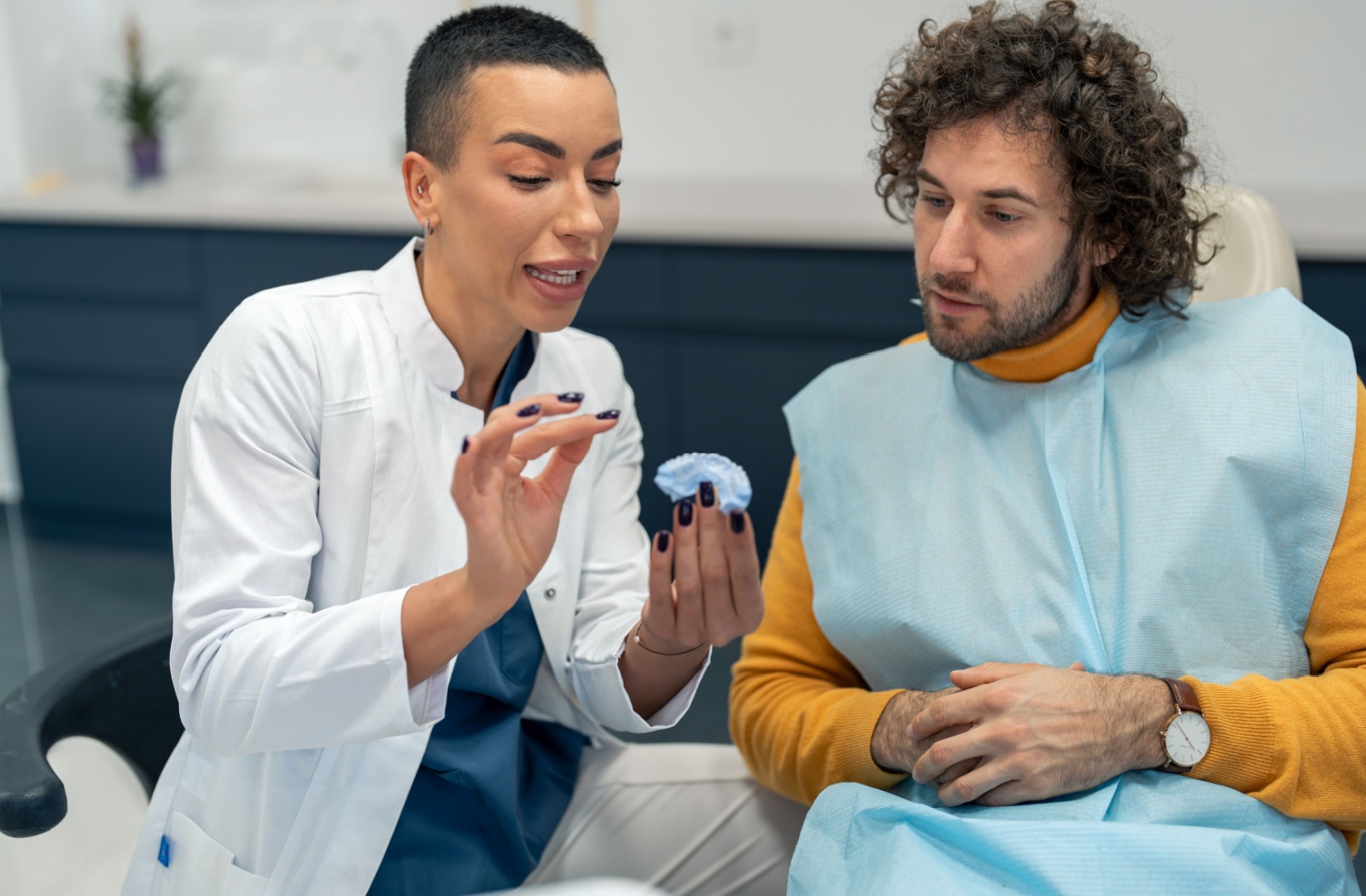 A patient carefully listens to their dentist explain an upcoming procedure as a way of dealing with dental anxiety