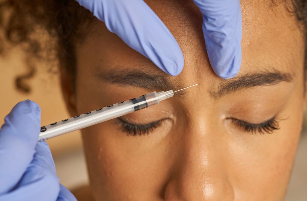 Close-up of an individual receiving a Dysport injection in the forehead to reduce wrinkles and improve skin appearance