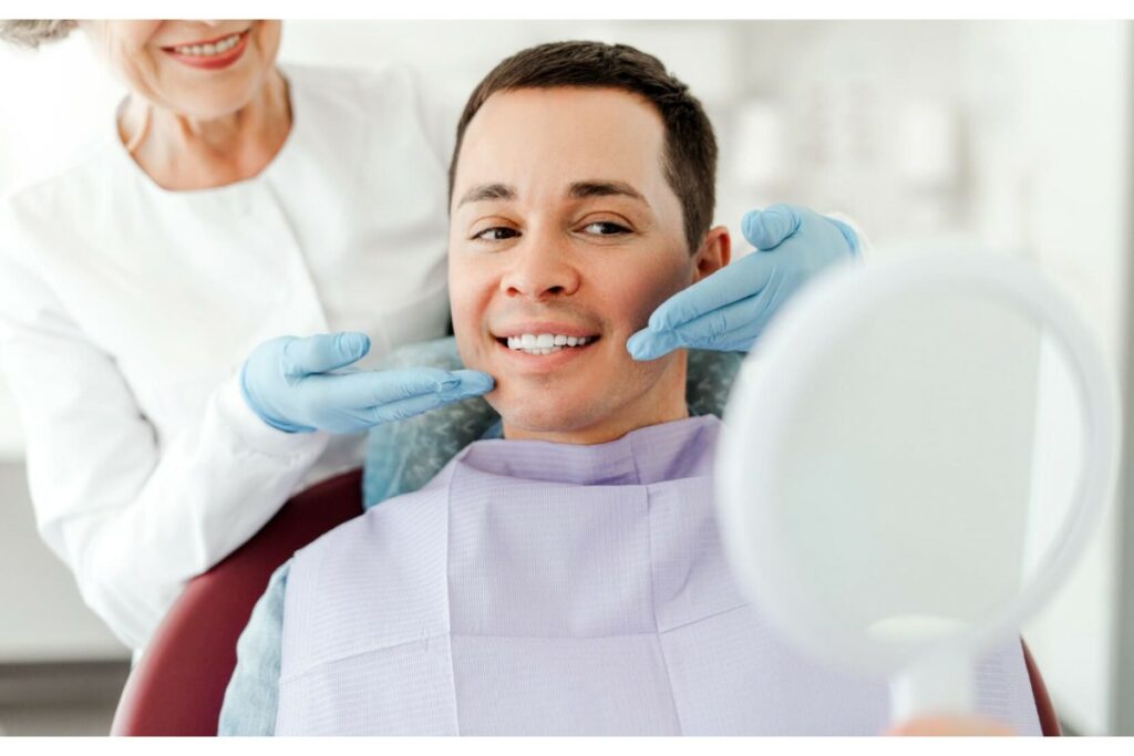 Male patient having his teeth looked at after appointment.