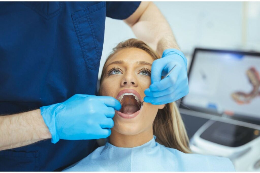 Female patient having her back teeth assessed by dentist.