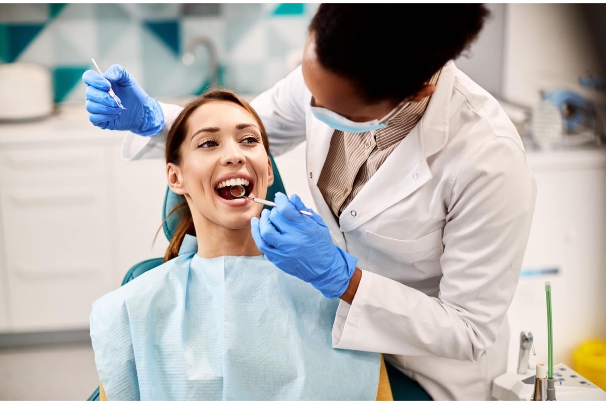 Female patient having her gums assessed.